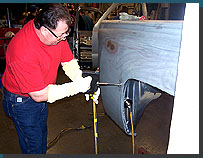 A student learning to use an electric dent puller